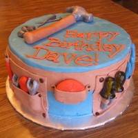 Handyman Birthday 10 inch chocolate. Frosted with ganache and then fondant. All fondant details.