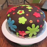 Flower Power Yellow cake with the dark chocolate satin ice fondant. Decorated with different size flowers. Reminds me of the 60's & 70's...