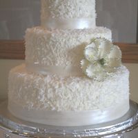 Coconut Cake Coconut covered cake with fondant painted bands and a sugarpaste flower.
