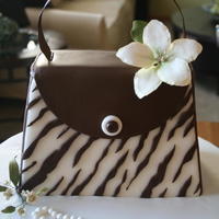 Kim's Purse Fondant covered chocolate mint cake with sugarpaste flowers and a sugar pearl bracelet.