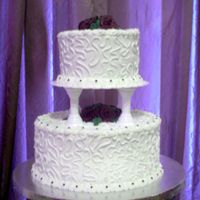 Wilton Course Iii Final Cake Butter Pecan cake with butter flavored buttercream icing, dark plum roses and cornelli lace. My first tiered cake.
