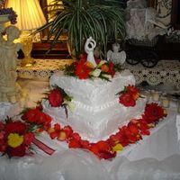 My First Wedding Cake Whipped cream frosting, fresh flowersBottom layer:Chocolate w/raspberry mousse & chocolate Ganache fillingTop Layer: Vanilla w/Bavarian...