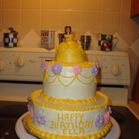 Belle 2 tier cake with mini wonder pan as belles dress. royal icing flowers, little belle doll