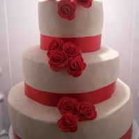 Julisa's Red Rose White cake filled with home made rasberry butter cream frosted with vanilla butter cream. Red roses made from fondant, using a 5 petal...