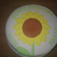Sunflower madeira cake covered in fondant icing. Sunflower and letters all fondant