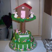 Easte Birthday Cake Coconut rum cake bottom tier, chocolate cake filled with buttercream, covered in fMMF, cardboard tree house covered chocolate MMF. MMF...
