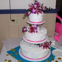 Round Hawaiian Themed Wedding Cake Tiered round cake with bright pink ribbon for a Hawaiian Themed wedding