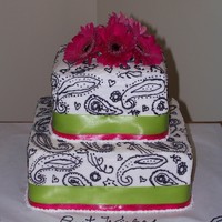 Paisley Bridal Shower Cake 9" and 6" Square cakes, iced in Buttercream, and decorated with buttercream. Satin ribbon, and real Gerbera Daisies.