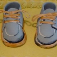 Boy Baby Shower I made these shoes to match the invitation. They are made of fondant. The cake is really plain except for the shoes. Vanilla cake with b/c...