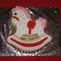 Rocking Horse A rocking horse pan with colors for a baby girl's Christmas-time baby shower. Buttercream stars.