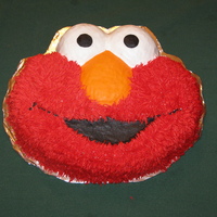 Elmo! Or as my 2-year-old says "Melmo!" Buttercream icing, the Wilton Elmo pan, grass tip for the fur.