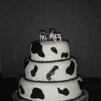 Cow Print Birthday Cake This cake was made for a girl who grew up on a dairy farm. 3-tier fondant cake with cow print cut outs and buttercream pearls.