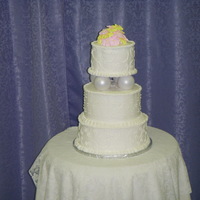 Primrose Wedding Cake 3-tier wedding cake made with buttercream and royal icing primroses on top.