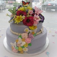 Butterfly And Flowers Bridal Shower Cake The bottom layer is chocolate cake with raspberry mousse filling and the top was a yellow cake with almond custard filling. It is iced in...