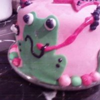 Frog Childrens Birthday Cake Frog birthday cake with tiara on top and lots of little bugs.