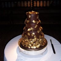 Gold Leaf Wedding Cake 4 tiers of chocolate truffle torte covered in chocolate fondant and decorated with cascading leaves cut from modelling chocolate and...