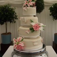 Sugar Flowers And Butterflies Wedding Cake Four tiers of traditional RIch Fruit cake, chocolate truffle torte and vanilla cake covered in ivory fondant and decorated with sugar...