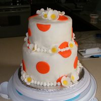My First Tiered Fondant Cake... White cake with chocolate and vanilla fillings. Rolled fondant decorations (circles & flowers).