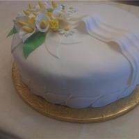 Calla Lillies 12 inch, three layer, french vanilla, strawberry filling, fondant, gumpaste roses.This is the cake I made for the funeral reception