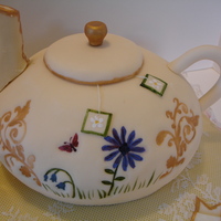 Tea Party Cake! Tea Party themed cake for a 5 y/o girl. Tea pot and tea cup are both cake. Tea bags are gum paste. I have strawberry butter cream in two of...