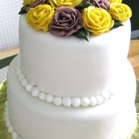 2 Tier Fondant With Roses 2 tier cake 6" and 8" covered in MFF, piped beads w/buttercream w/buttercream roses on top.