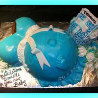 Baby Belly chocolate cake w/BC. Covered with MMF. I made a baby rattle with MMF and RKT. painted it with silver luster dust.