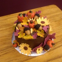 Autumn Harvest fondant pumpins, sunflowers, and leaves, caramel acorns, chocolate buttercream icing