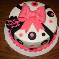 Pink And Black Bow Birthday Cake This is a 2 layer 9" filled cake that I made for a coworker. Buttercream icing and fondant decorations.