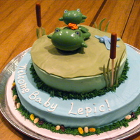 Froggy Baby Shower Cake Frosted in buttercream, fondant lily pad and other decorations, plastic frogs
