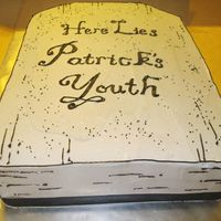 Headstone Cake This is 2 13x9 white cakes with strawberry filling. Trimmed top corners so it would resemble a tombstone. The client asked for cream cheese...