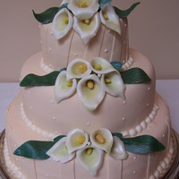 Calla Lily Wedding Ivory fondant cake with light off white dots, along with gumpaste calla lilies on it.