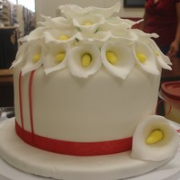 Calla Lilies! Chocolate cake with chocolate peanut butter fudge fillng covered in fondant. Flowers are made of fondant.