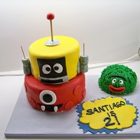 Yo Gabba Gabba Santiago Is 2 2 layer, 2 tiered WASC cake covered in MMF. Smash cake is also WASC baked in a stainless steel bowl:) Covered in buttercream with grass tip...
