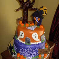 Two Tier Halloween Cake This was made as a Halloween Birthday cake, complete with ghosts, gravestones, bones, pumpkins, signs, witches legs & hat, haunted...
