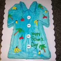Father's Day Cake Hand carved Father's Day cake with Buttercream icing in a two-toned blue for the hawaiian shirt effect with candy runts, lifesavers...