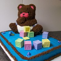 Teddy Bear Baby Shower Cake Teddy bear baby shower cake done with buttercream icing. The teddy bear was done with the teddy bear pan and piped stars. The plastic...