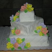 First Wedding Cake This was done entirely by my 15 year old daughter. White fondant covered cake with quilted pattern. The flowers and leaves are Royal Icing...