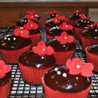 Valentines Day Cupcakes Chocolate cupcakes filled with raspberry mousse dipped in Chcolate ganache. Fondant flowersw