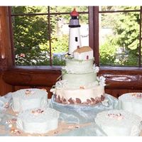 The Lighthouse This bride and groom wanted a replica of their favorite light house with a feeling of a cliff and waves. I used pieces of white and milk...