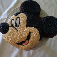Mickey Mouse I made this cake for my baby's 2nd birthday. I used the Mickey Mouse pan from Wilton. Ideally, I had to do buttercream frosting so my...