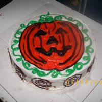 Halloween Pumpkin This cake was a 9inch round white cake.Jack-O-Lantern style Pumpkin on the top, with spider webs on the sides.