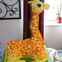 Giraffe strawberry cake with strawberry buttercream. rice crispy treats neck, all covered in mm fondant.