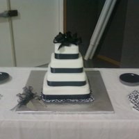 Black And White With Bow 12", 10", 8". 6" with MMF. This was my first wedding cake and a gift to the bride.
