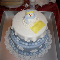Snowman Babyshower 10" yellow with buttercream and 8" chocolate with buttercream. Fondant snowman and royal icing snowflakes.