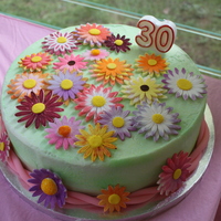 30Th Birthday Cake This is a buttercream covered cake, with fondant flowers and rope around the bottom. It is a lemon cake with a raspberry buttercream...