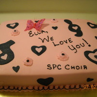 Ella's Cake This was for a choir member who is moving away. It is white cake with strawberry filling and strawberry flavored buttercream under the...