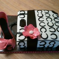 Purse/shoe vanilla cake with vanilla buttercream. covered in MMF. Gumpaste flower, and shoe.