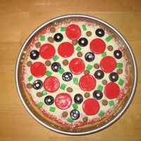 Picture_046.jpg Supreme pizza! So easy. The kids made all the fondant parts...pepperoni, sausage, green peppers, and black olives. The only hard part was...