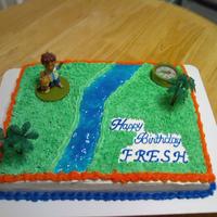 Go Diego Go diego figurine, compass and trees purchased from cake supply store, grass tip used and tinted piping gel for water.