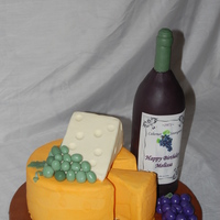 Wine & Cheese Tray Wine bottle is RKT covered in fondant. "Cheeses" are frosted in buttercream, with fondant grapes. TFL!!